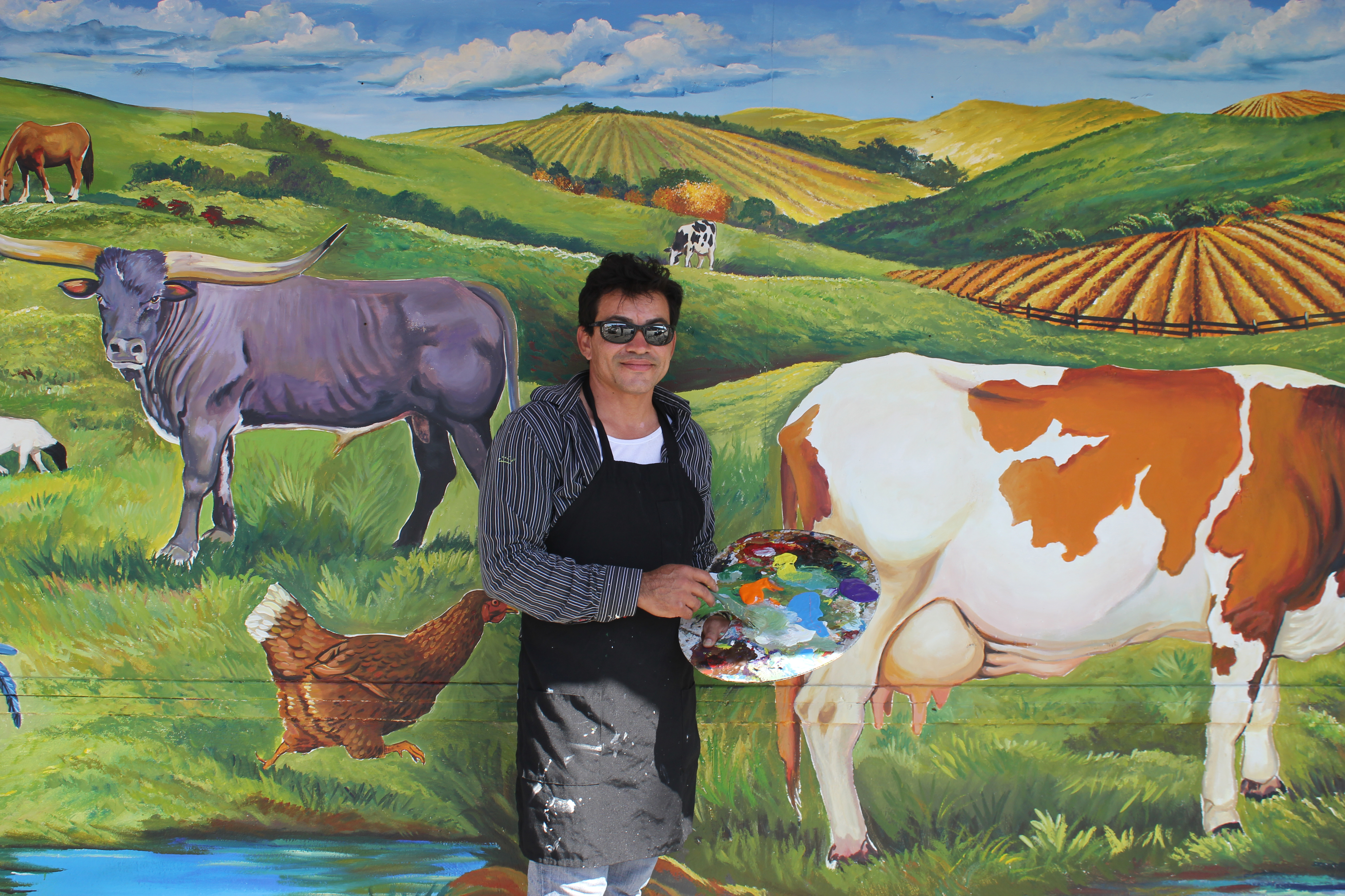 Roberto painting a mural